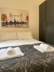a bedroom with a bed with towels on it at Amazing Studio Room 1 - East Ham/East London in London