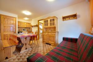 a kitchen with a table and a couch in a room at Casa Guana in Livigno