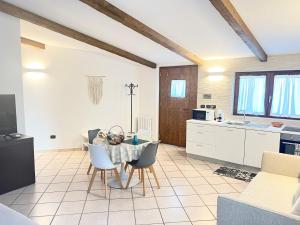 a kitchen and living room with a table and chairs at I trulli di Eva in Noci