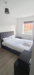 a bedroom with a large bed with a window at H8 Room 2 Quiet place with 15 min walk to City Centre, Free car parking, Late night Checkin Anytime ,2min walk to bus stop in Manchester