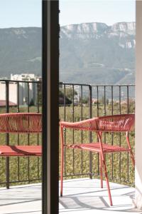 a red bench sitting on top of a balcony at Kaiserau-Höfl in Bolzano