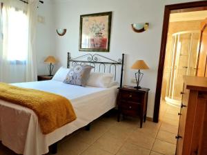 a bedroom with a bed with white sheets and pillows at Villa Lagarto heated pool aircon central Playa Blanca in Playa Blanca