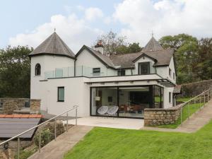 a large white house with a patio and grass at Glamorgan House in Cardiff