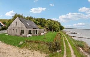 a house on the shore of a body of water at Lovely Home In Fredericia With House Sea View in Fredericia
