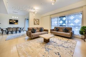 a living room with two couches and a table at Jumeirah Beach Residence - Rimal 4, Dubai Marina in Dubai
