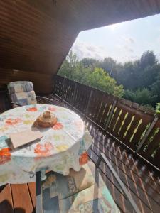 a table and chairs on a balcony with a view at Fewo "Lütt Stuv" in Fockbek