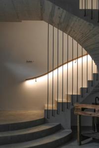 klatka schodowa z oświetleniem na ścianie i ławką w obiekcie Kaiserau-Höfl w mieście Bolzano