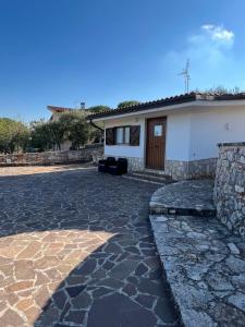 a house with a stone driveway in front of it at I trulli di Eva in Noci