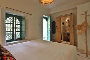 a bedroom with a large bed and a window at Riad NaaNaa Bed & Breakfast in Marrakech