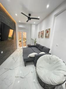 a living room with a couch and a tv at Zeos finest jacuzzi Suite in Athens