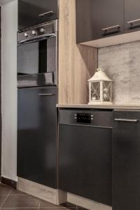 a kitchen with a black refrigerator and a stove at Deluxe Quentin Apartment next to the Heroes Square in Budapest