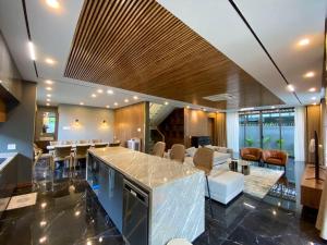 a kitchen and living room with a bar and a couch at Song Cat villa - 49DP8 in Danang +51 photos