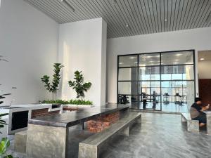 a lobby with a table and benches in a building at Chambers luxury suites KLCC in Kuala Lumpur