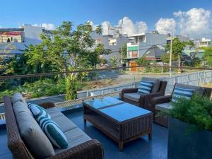 a patio with couches and chairs and a table at Song Cat villa - 49DP8 in Danang