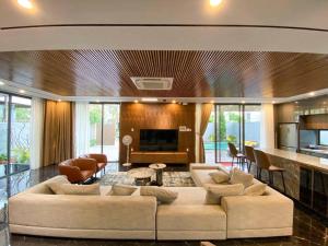 a living room with a large couch and a fireplace at Song Cat villa - 49DP8 in Danang