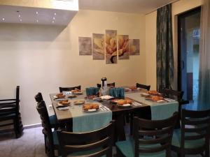 a dining room with a table with food on it at Къща за гости M-Stone in Bansko