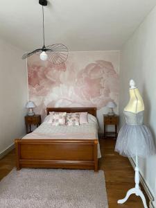 a bedroom with a bed and a wall with flowers at La belle Charentaise in Vaux-Rouillac +6 photos