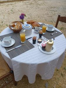 a white table with food and drinks on it at Domaine des Mauves in Berbiguières