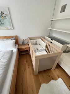 a small bedroom with a bed and a table at Apartment Enarina in Telfs in Telfs