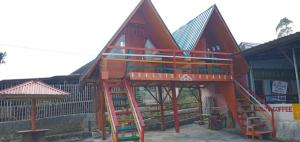 a large building with a playground with a ladder at Homestay Subarda Kamar Natural in Solok