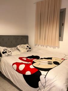 a bedroom with two beds with a table on it at Suite 24/7-סוויטת 24/7 in Ramat Gan
