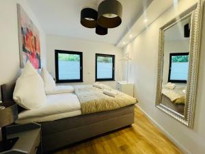 ein Schlafzimmer mit einem Bett und einem großen Spiegel in der Unterkunft Der Vitihof Pastoren Suite in Osnabrück