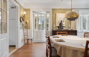 a dining room with a table and a chair at Beautiful Home In Faaborg With Wifi in Faaborg