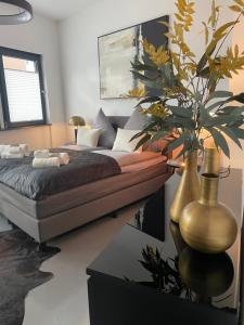 a bedroom with a bed and a potted plant at Der Vitihof Loft in Osnabrück