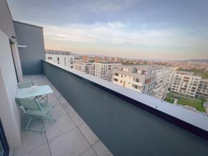 a balcony with a table and a view of a city at ART Apartment II in Târgu-Mureş