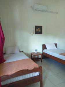 Postel nebo postele na pokoji v ubytování Hotel Tentrem Syariah