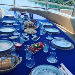 a blue table with plates and bowls of food on it at Bluemarmarisgulettour in Marmaris