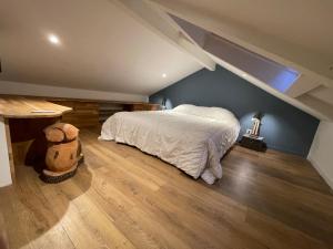 a bedroom with a large bed in a attic at maison colmars in Colmars