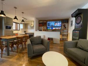 a living room with a table and a dining room at maison colmars in Colmars