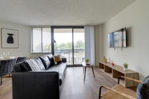 a living room with a couch and a table at Modern Apartment in the Center at Pentagon City in Arlington