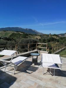 two chairs and a table on a patio with mountains at CASA LINARA in Frontino