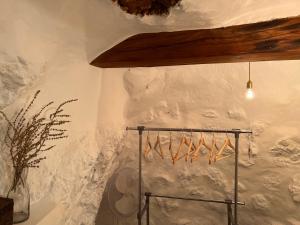 a room with a white wall with a bunch of hangers at La Casilla del San Antón in Níjar