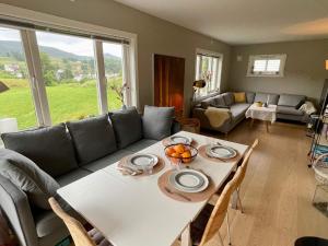 a living room with a table and a couch at 6 person holiday home in Bjoa-By Traum in Utbjoa