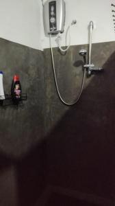 a shower in a bathroom with a shower head at HOME HOSTEL ELLA private rooms only in Ella