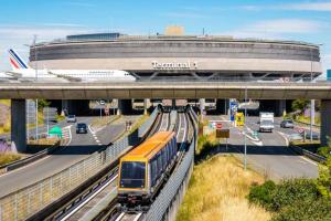 a train on the tracks in front of an airport at StudioNeuf équipé CDG/Parc Expo/ Paris in Aulnay-sous-Bois