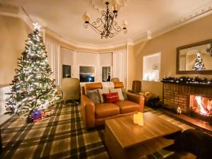 a living room with a christmas tree and a couch at Thornbank in Millport