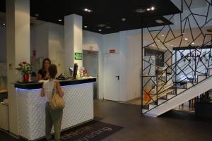 two women standing at a counter in a building at Mayerling Hotel in Madrid