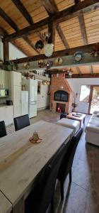 a large dining room with a large wooden table and chairs at Casa Bella in Vadu Moţilor