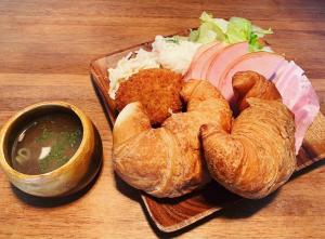 a plate of food with bread and meat and a bowl of dipping sauce at Starry Sky and Sea of Clouds Hotel Terrace Resort - Vacation STAY 51662v in Takeda