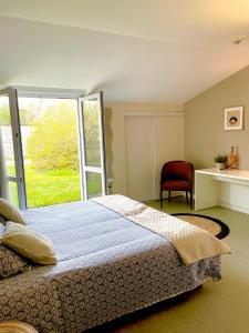 a bedroom with a bed and a window at Chambres Domaine de Laléard in Saint-Hilaire-de-Villefranche +28 photos