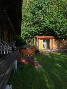 patio trasero con banco de madera y bañera de hidromasaje en Saun ööbimisega, en Vehendi