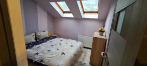 a small bedroom with a bed with blue stars at Comfort Home Apartment 3 in Petroşani