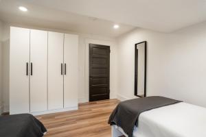 a bedroom with white cabinets and a black door at The Buckeye Retreat Mansion in Columbus