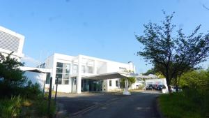 a white building with a parking lot in front of it at Starry Sky and Sea of Clouds Hotel Terrace Resort - Vacation STAY 51669v in Takeda