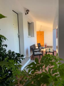 a porch with two chairs and a table at Hideaway Haven Villa in SantʼAnna Arresi +32 photos