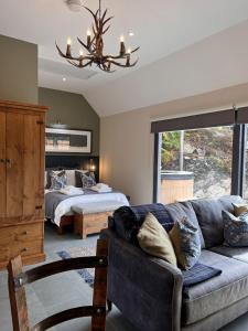 a living room with a couch and a bed at Raasay Studio Lodge in Arisaig